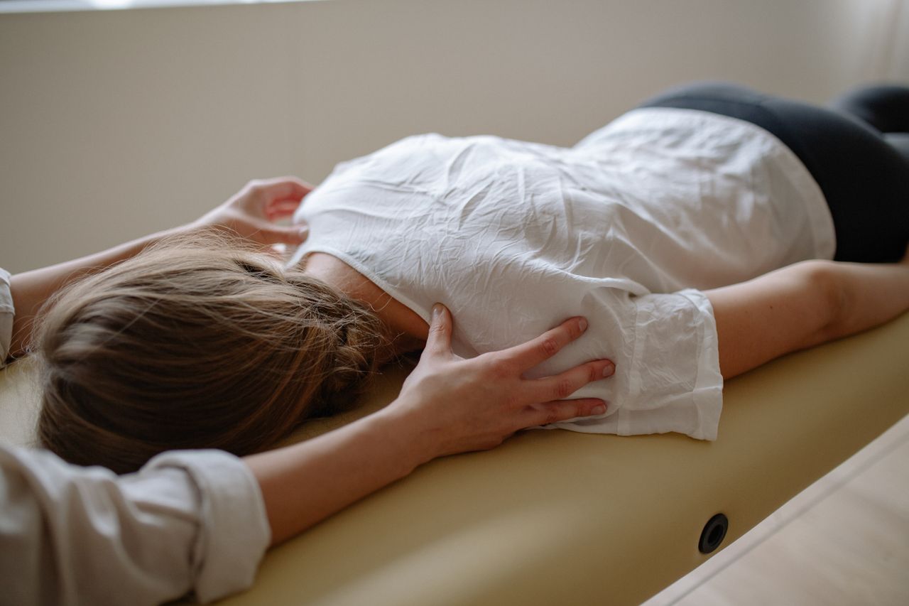 Mastering the First Impression: Your intriguing post title goes here A woman receiving a calming massage therapy session on a comfortable table.