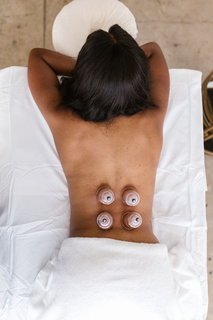 services-img Back view of a woman receiving cupping therapy in a spa, promoting wellness and relaxation.